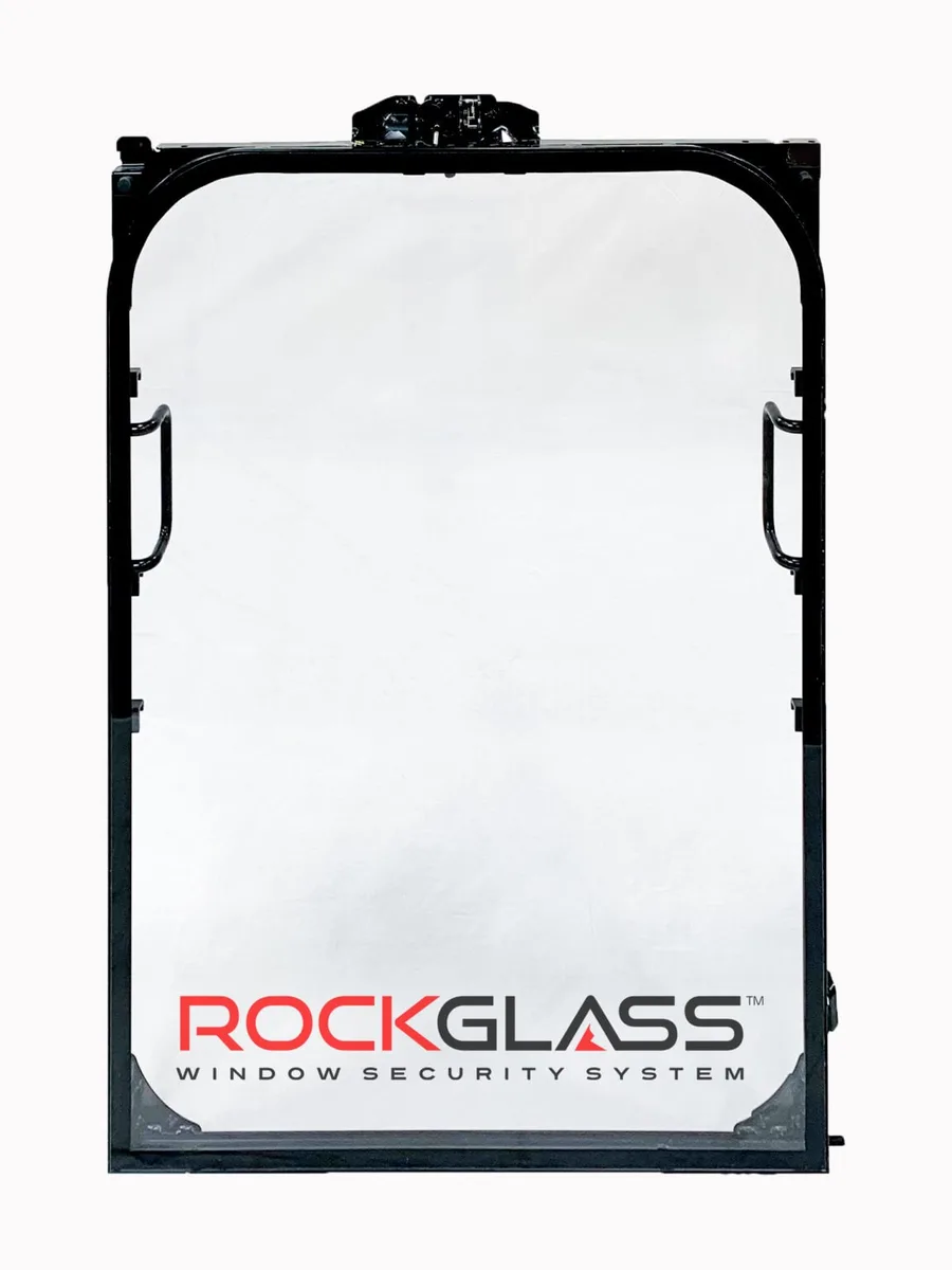 Technician installing security glass into a heavy machinery operator cab